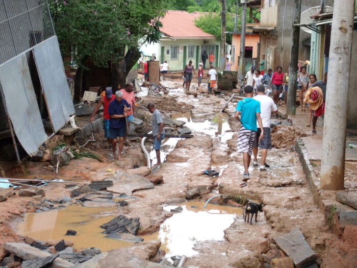 People walking around puddles after serious flooding