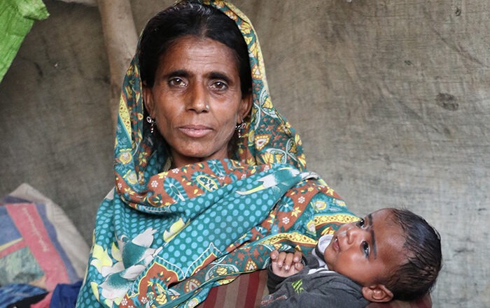Lady in a headscarf holding a baby