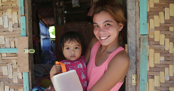 woman holding a child with a solar light