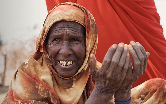 Frau mit orangenem Kopftuch in Somaliland