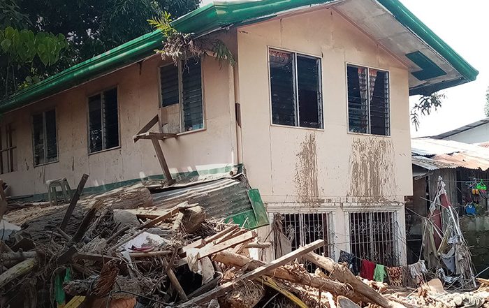 House surrounded by rubble in the Philippines