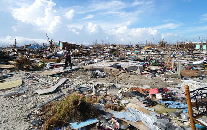 Person walking through rubble left behind by Hurricane Dorian
