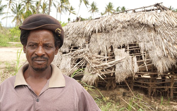 Man outside a damaged shelter in Kenya