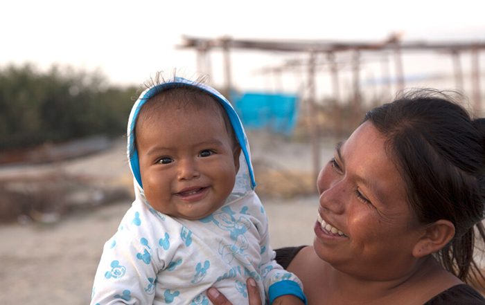 Woman holding her baby in Peru