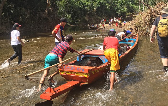 People pushing aid in boat