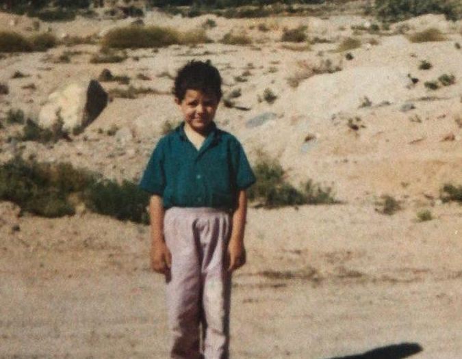 Ein Junge in blauem T-Shirt und brauner Hose