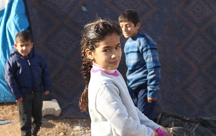 Children outside a tent in Syria