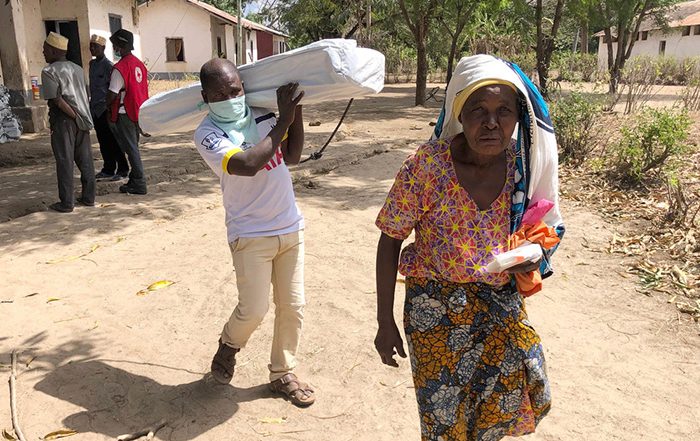 Woman and man holding aid in Tanzania