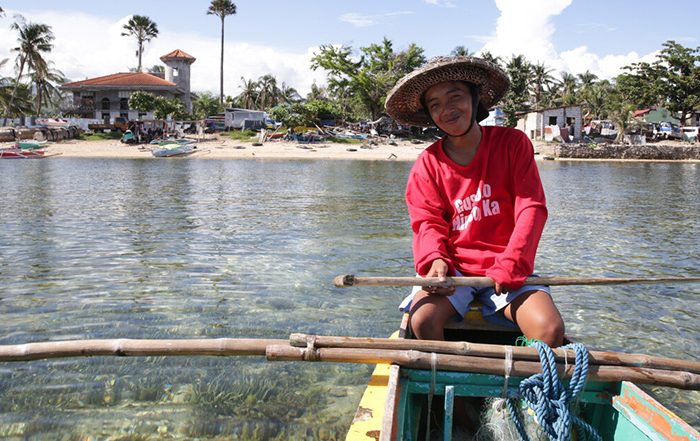 Person sitting in a boat off the coast of the Philippines