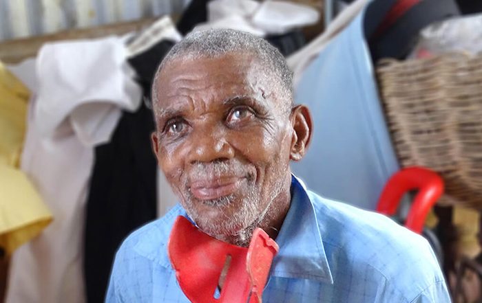 Man holding a red crutch