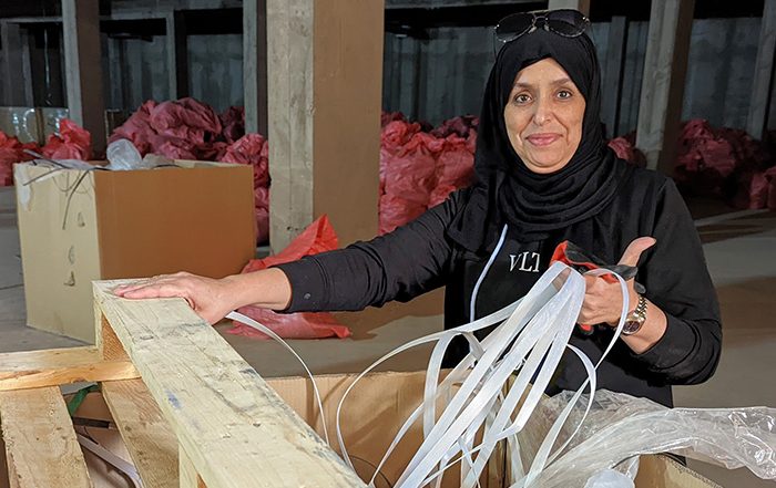 Woman with aid packaging in a warehouse in Morocco