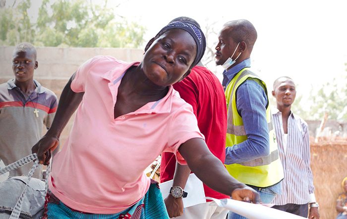 Woman carrying bag of aid in Nigeria