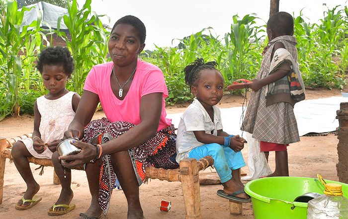 Woman and children cleaning a kitchen set in Mozambique
